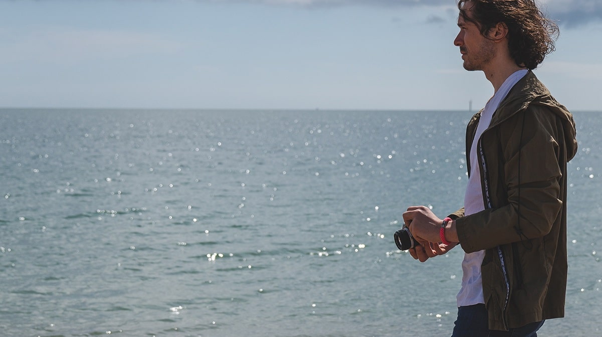 Man wearing bright rope bracelet by sea
