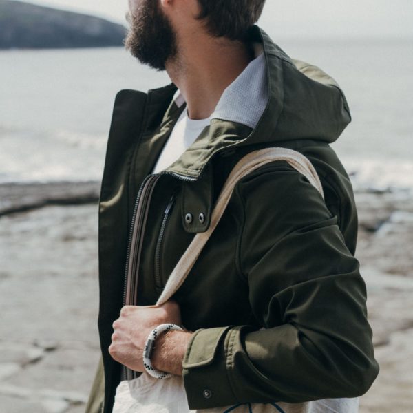 Man wearing white rope bracelet on beach