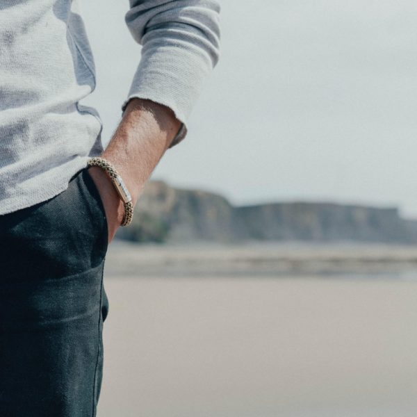 Man wearing mushroom rope bracelet