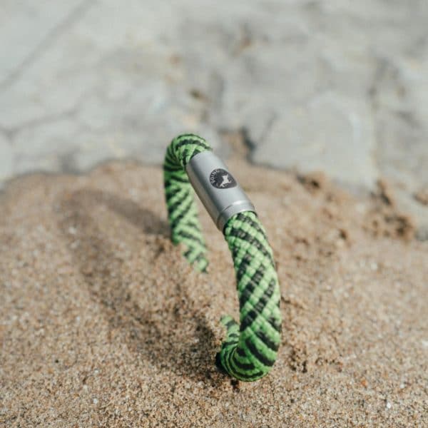 Green rope bracelet in the sand