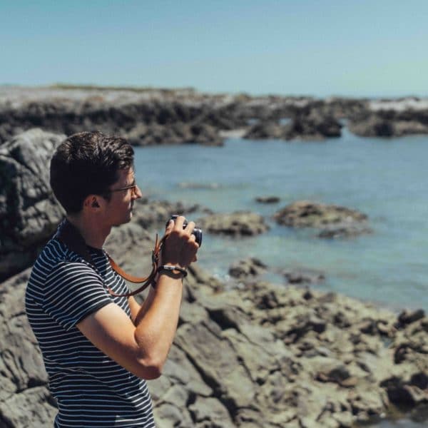 Man wearing black climbing rope bracelet by the sea