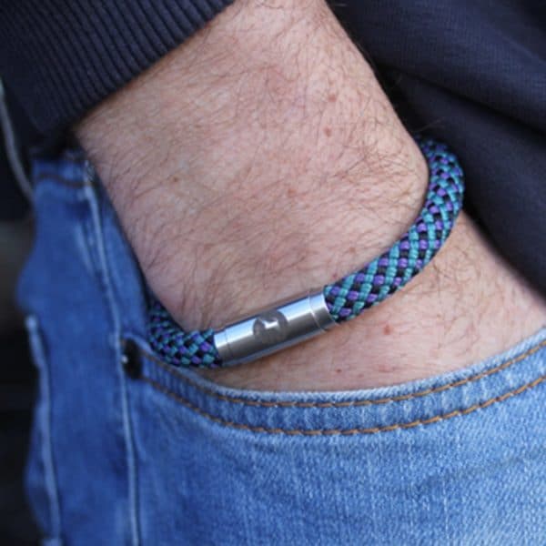 Man wearing teal climbing rope bracelet