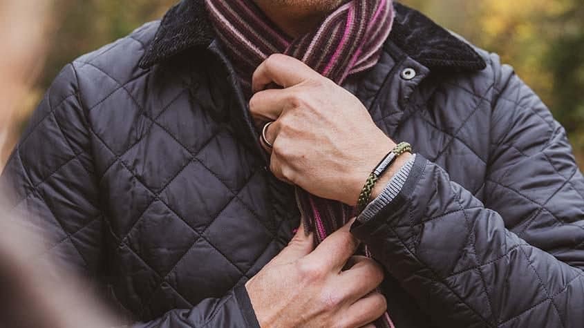 Man wearing green climbing rope bracelet in Autumn