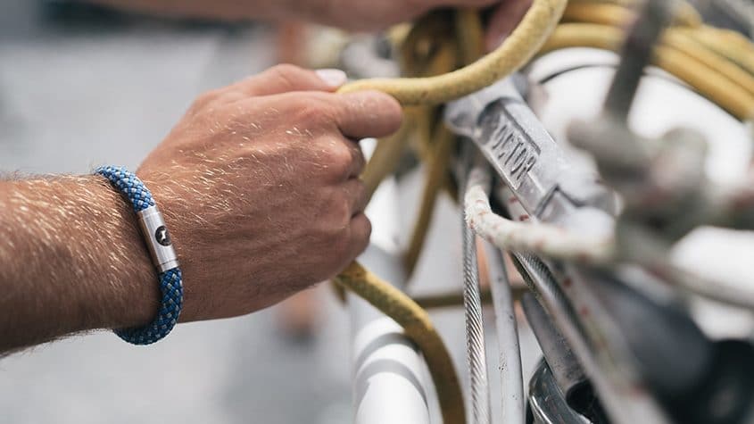 Man wearing blue climbing rope bracelet