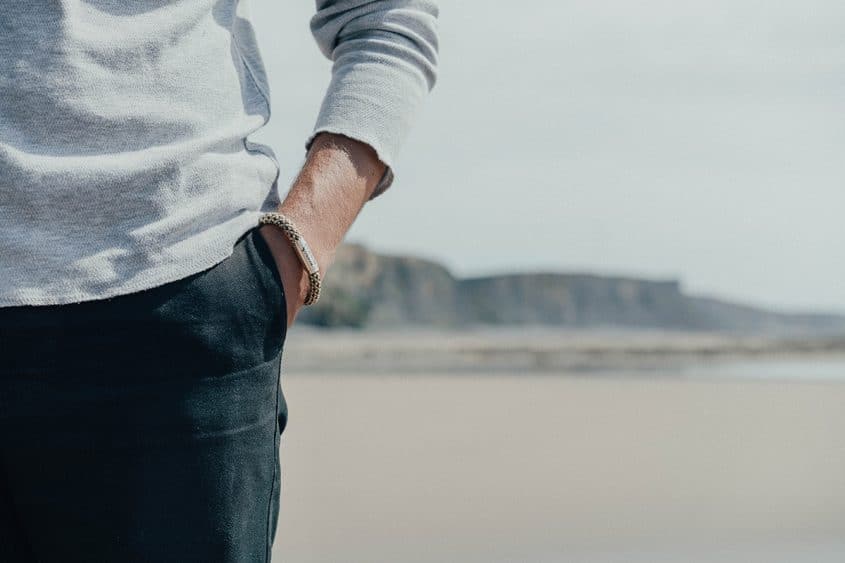 Man wearing mushroom rope bracelet on beach