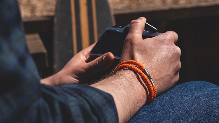 Man wearing orange paracord bracelet