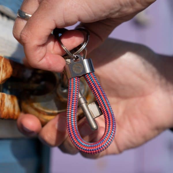 Man using red and white striped steel rope key fob key ring